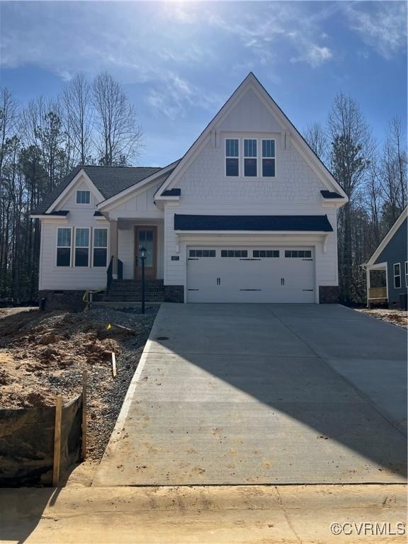 craftsman inspired home featuring driveway and an attached garage