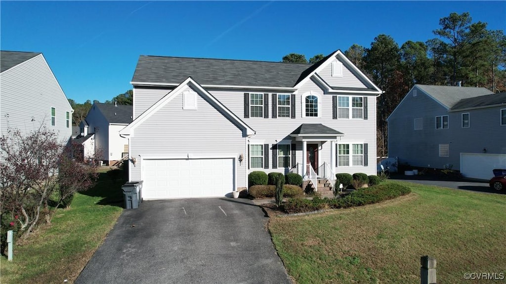 view of front of home featuring a front yard and a garage