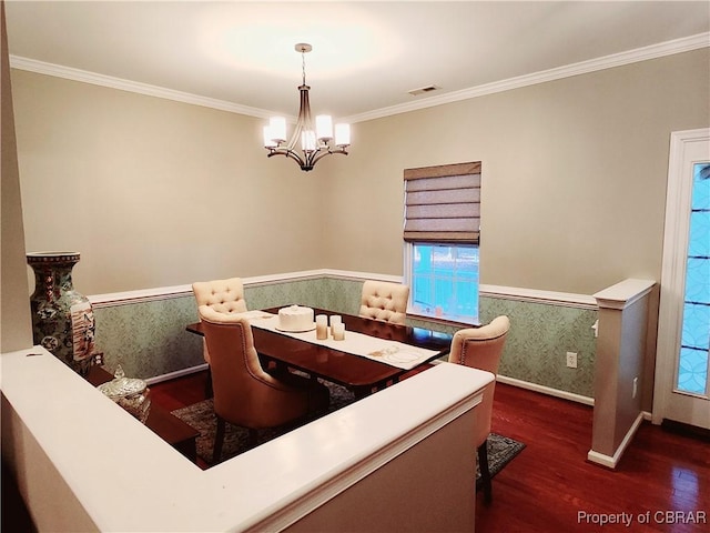 dining area with ornamental molding, dark hardwood / wood-style floors, and a notable chandelier