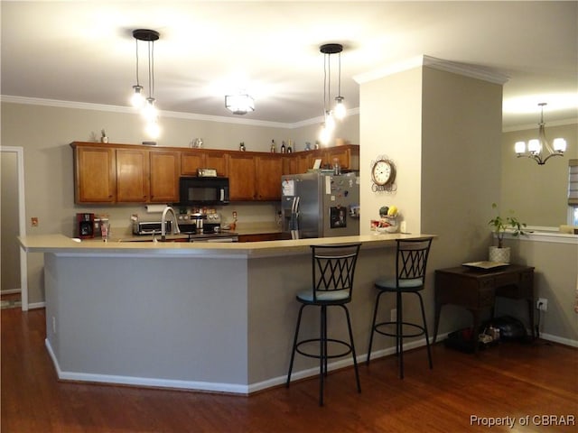 kitchen with kitchen peninsula, stainless steel appliances, decorative light fixtures, and an inviting chandelier