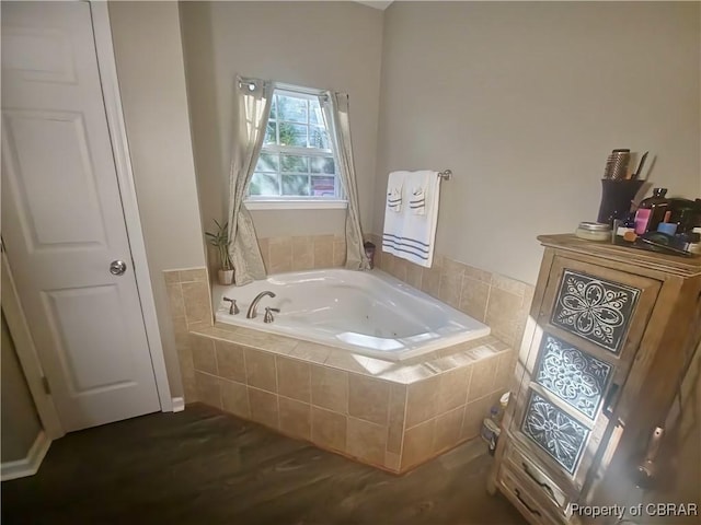 bathroom featuring wood-type flooring and tiled bath