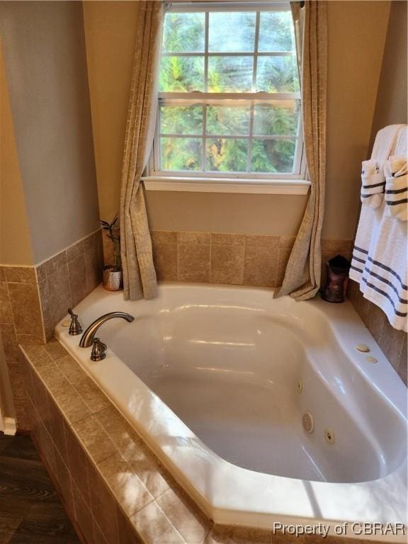 bathroom featuring a relaxing tiled tub