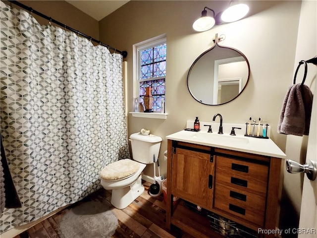 bathroom featuring hardwood / wood-style floors, vanity, and toilet