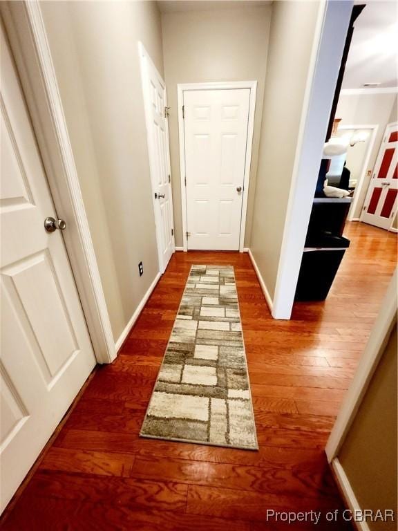 hallway with hardwood / wood-style flooring