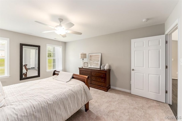 bedroom with ceiling fan and light colored carpet