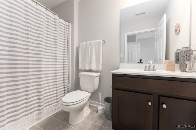 bathroom with tile patterned floors, vanity, and toilet