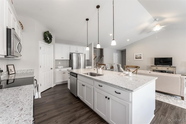 kitchen featuring white cabinetry, sink, lofted ceiling, a kitchen island with sink, and appliances with stainless steel finishes