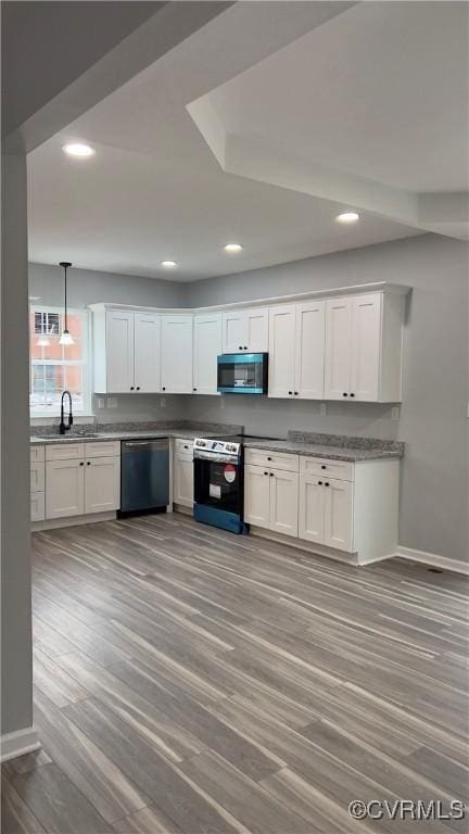 kitchen featuring white cabinets, sink, appliances with stainless steel finishes, and light hardwood / wood-style flooring