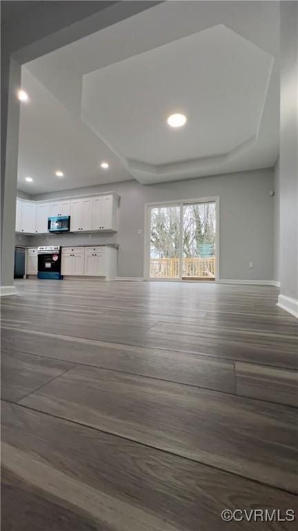 unfurnished living room with dark hardwood / wood-style floors