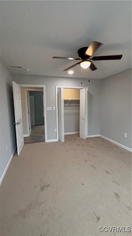 unfurnished bedroom with light carpet, a closet, and ceiling fan