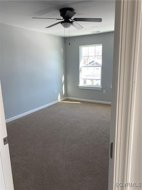 carpeted spare room with ceiling fan