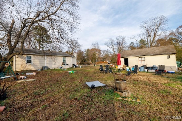 view of yard featuring central AC unit and an outdoor structure