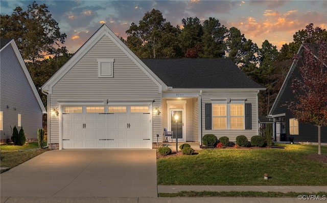 view of front facade with a garage and a lawn