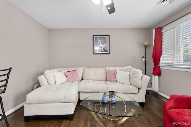 living room featuring ceiling fan and dark hardwood / wood-style floors