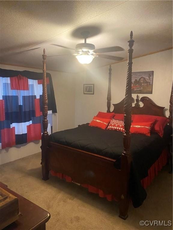 carpeted bedroom with ceiling fan and a textured ceiling