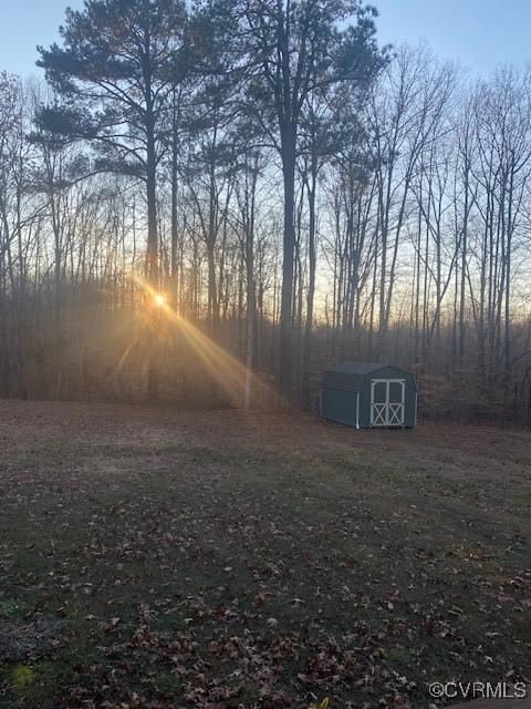 yard at dusk with a storage unit