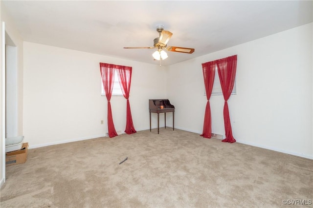 carpeted spare room with ceiling fan