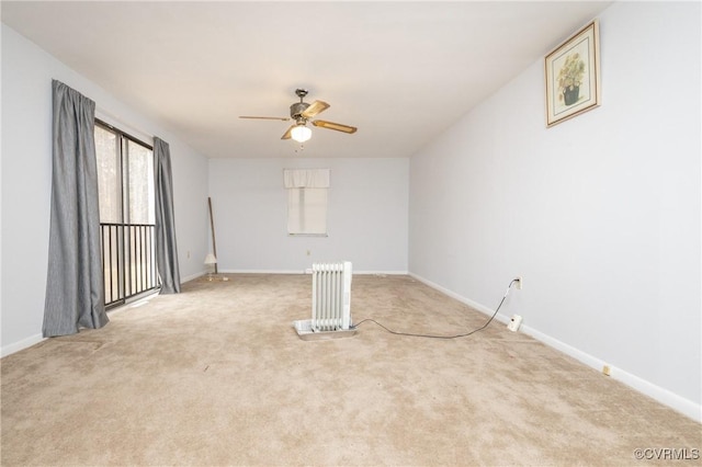 empty room featuring ceiling fan and light colored carpet