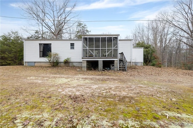 rear view of house featuring a sunroom