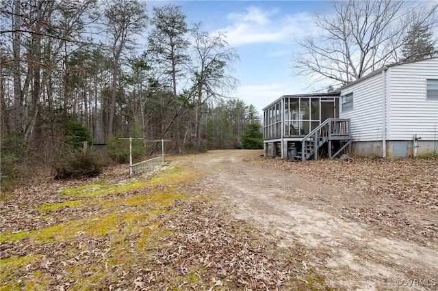 view of yard with a sunroom