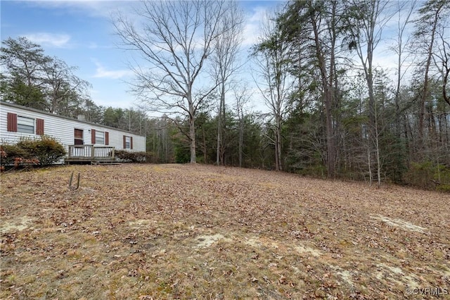 view of yard featuring a wooden deck