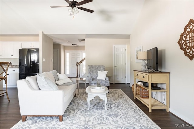 living room featuring ceiling fan and dark hardwood / wood-style floors