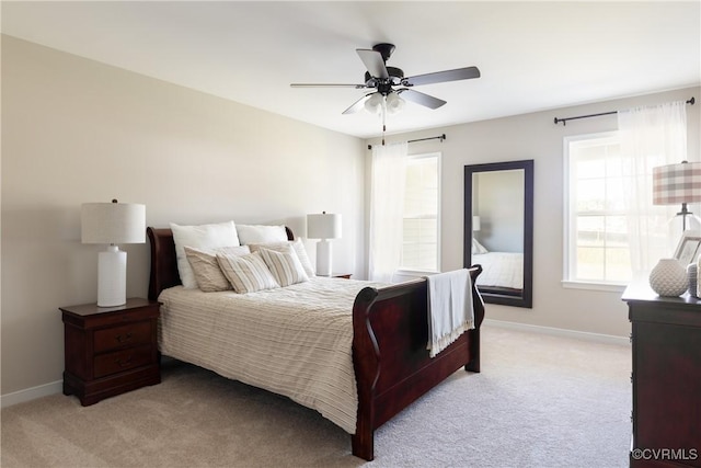 bedroom with ceiling fan and light colored carpet