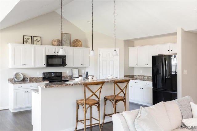 kitchen with black appliances, decorative light fixtures, white cabinets, and dark stone countertops