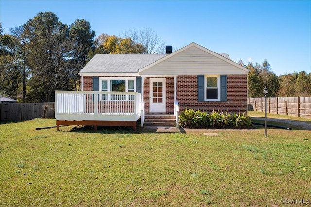 view of front facade with a front yard and a wooden deck