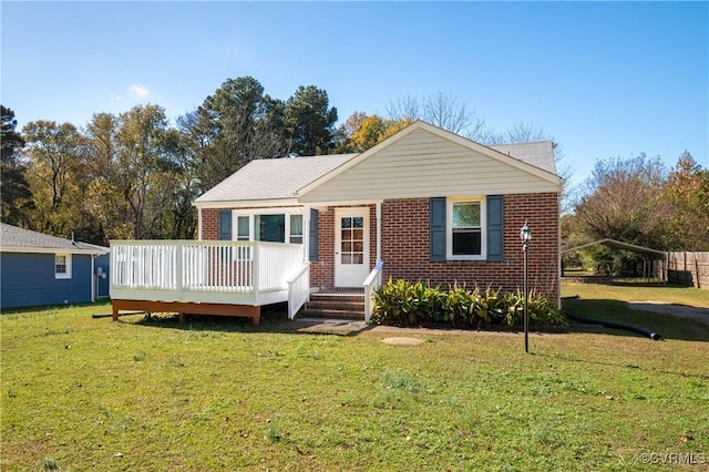 view of front of home featuring a wooden deck and a front lawn