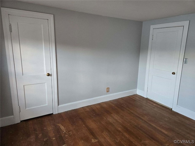 spare room featuring dark hardwood / wood-style flooring