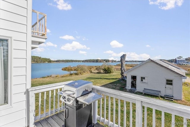 deck featuring area for grilling and a water view