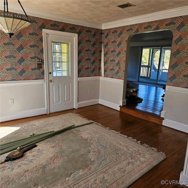 foyer with hardwood / wood-style flooring and ornamental molding