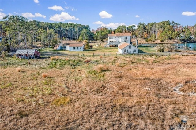 view of yard featuring a rural view and an outbuilding