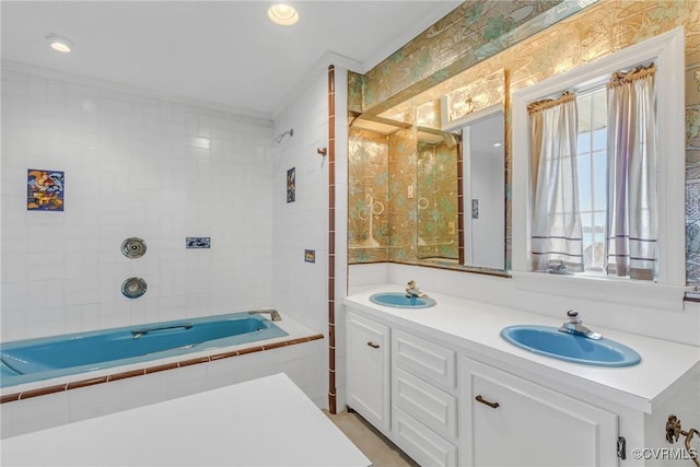 full bath featuring double vanity, recessed lighting, tiled shower / bath combo, and a sink