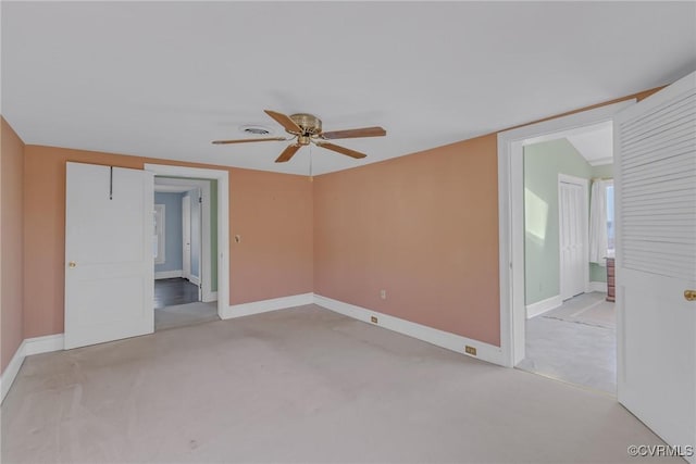 unfurnished room featuring baseboards, light colored carpet, and a ceiling fan