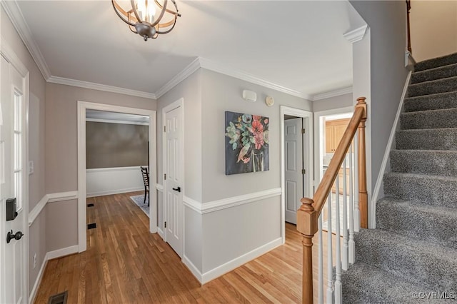 interior space with hardwood / wood-style floors and crown molding