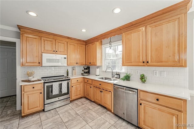 kitchen featuring sink, crown molding, tasteful backsplash, and appliances with stainless steel finishes