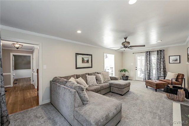 living room featuring ceiling fan, crown molding, and carpet floors