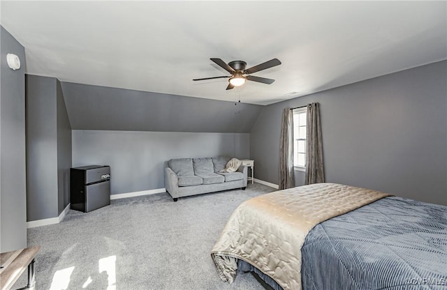 bedroom featuring light colored carpet, vaulted ceiling, and ceiling fan