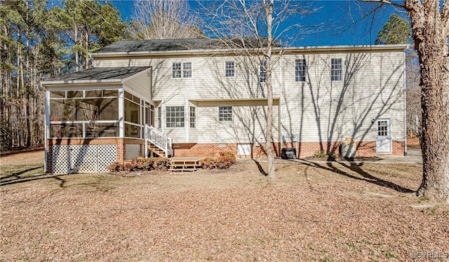 back of house featuring a sunroom