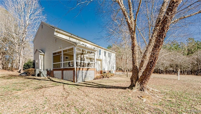 view of home's exterior with cooling unit and a sunroom