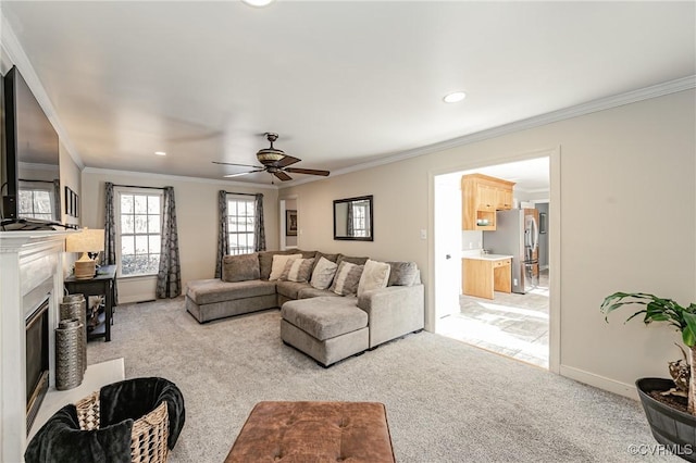 carpeted living room with ceiling fan and ornamental molding