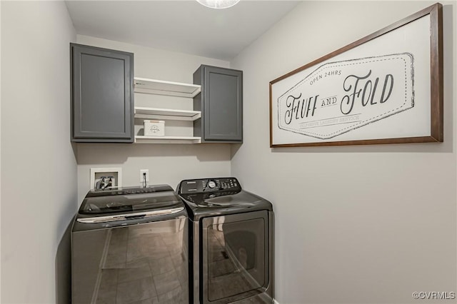 washroom featuring cabinets and independent washer and dryer