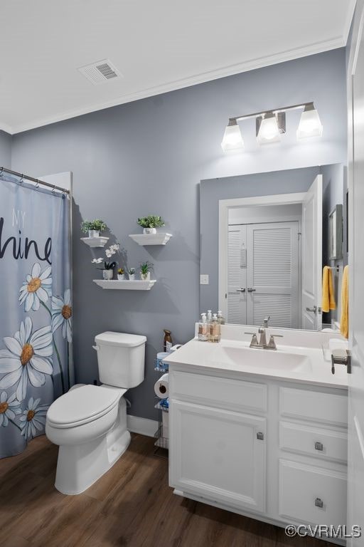 bathroom with vanity, wood-type flooring, toilet, and walk in shower