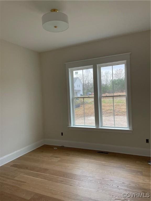 unfurnished room with light wood-type flooring