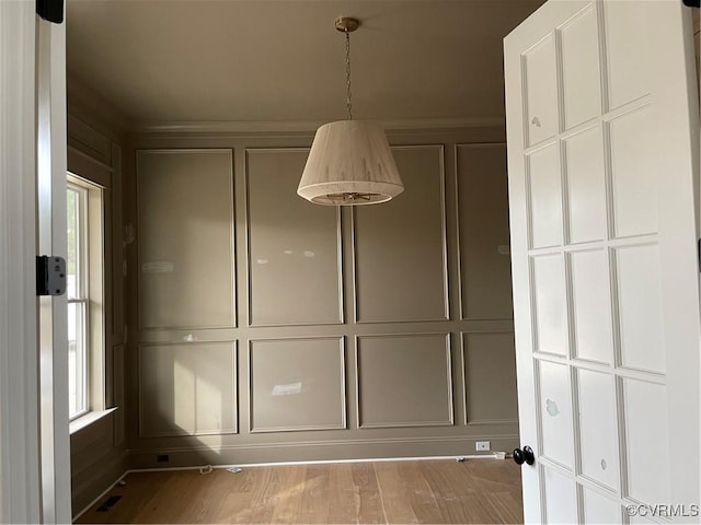 unfurnished dining area featuring light hardwood / wood-style floors