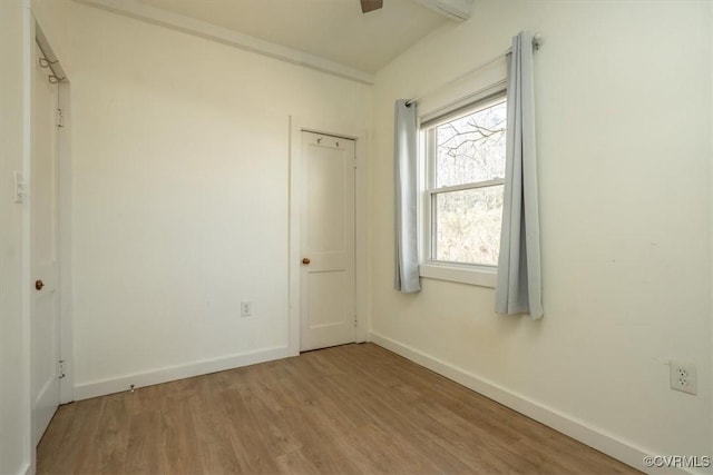 spare room featuring hardwood / wood-style floors and a wealth of natural light