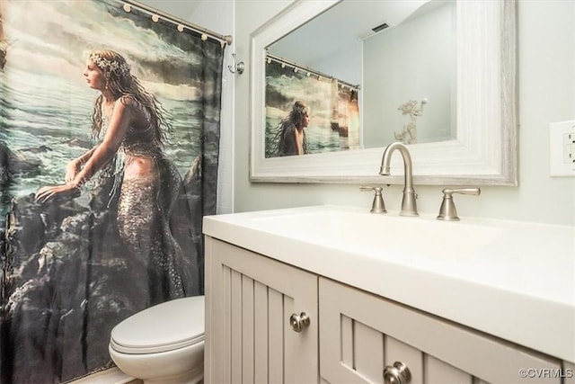 bathroom with toilet and vanity