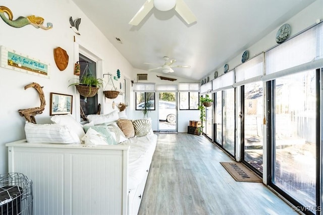 sunroom / solarium featuring ceiling fan and vaulted ceiling